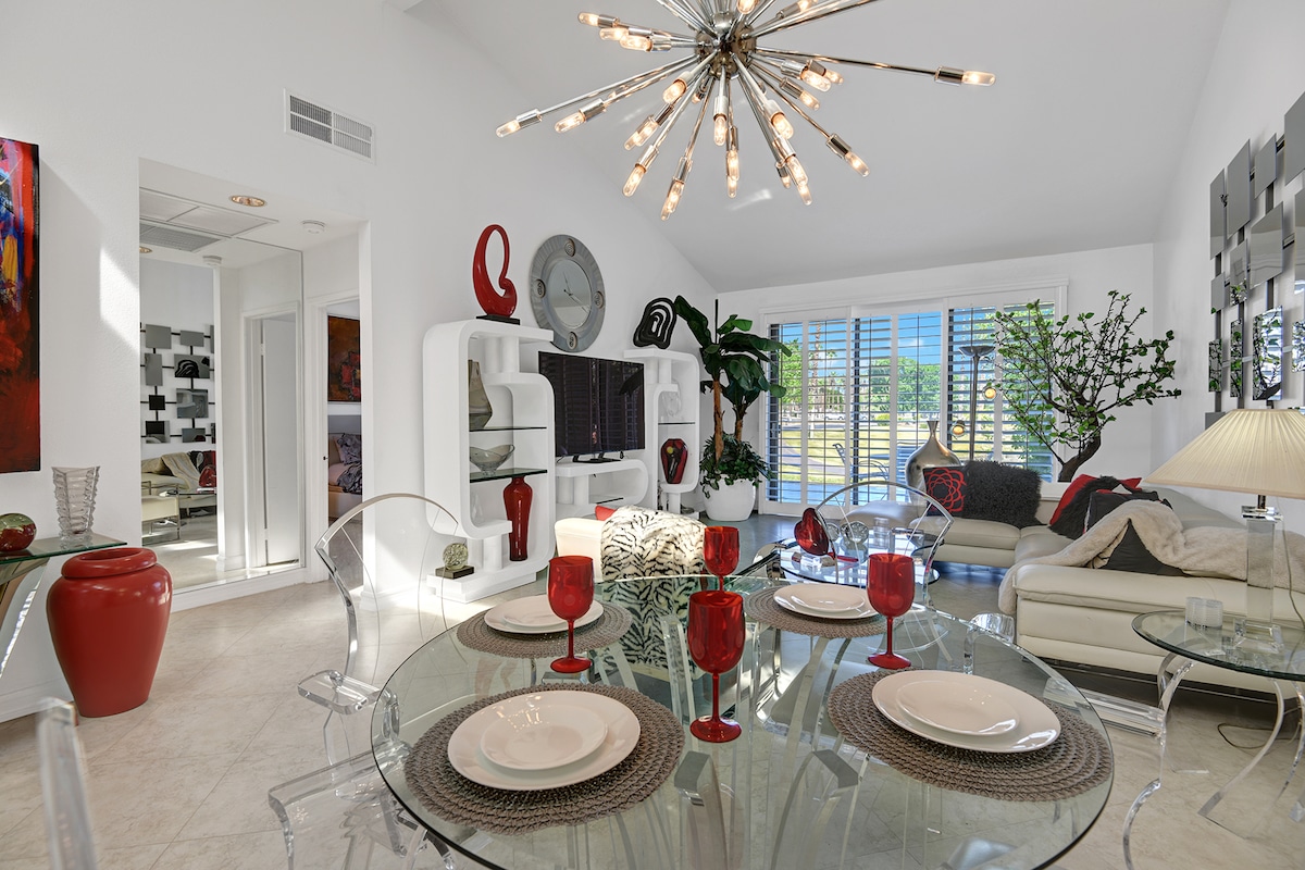 Step into this stylish, light-filled retreat where modern elegance meets comfort. A dramatic starburst chandelier and sleek glass dining table create the perfect contemporary dining space.