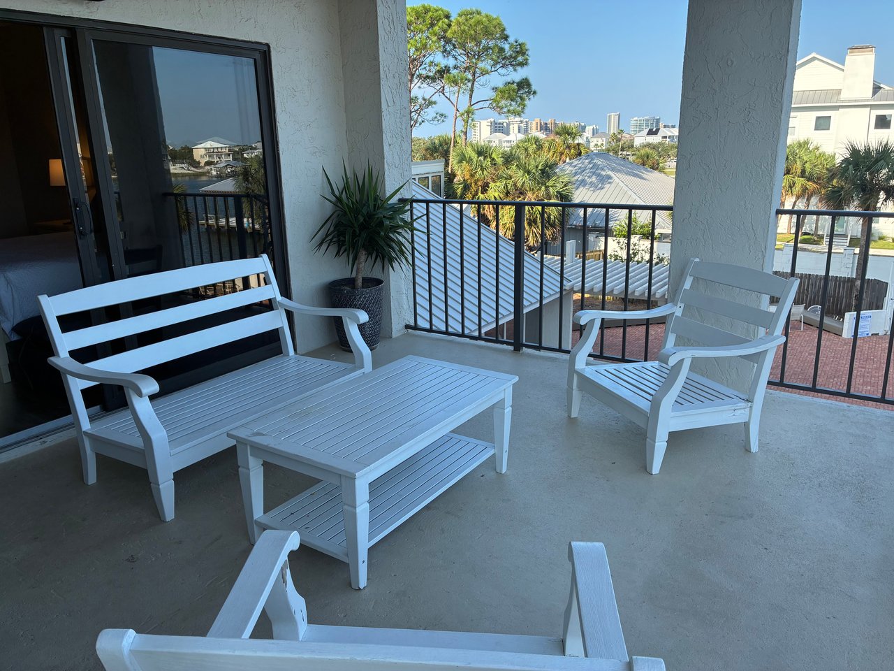 Sip your morning coffee on your private balcony and take in the peaceful mix of lush palms and distant city skyline—a perfect spot to unwind after a day of exploring.