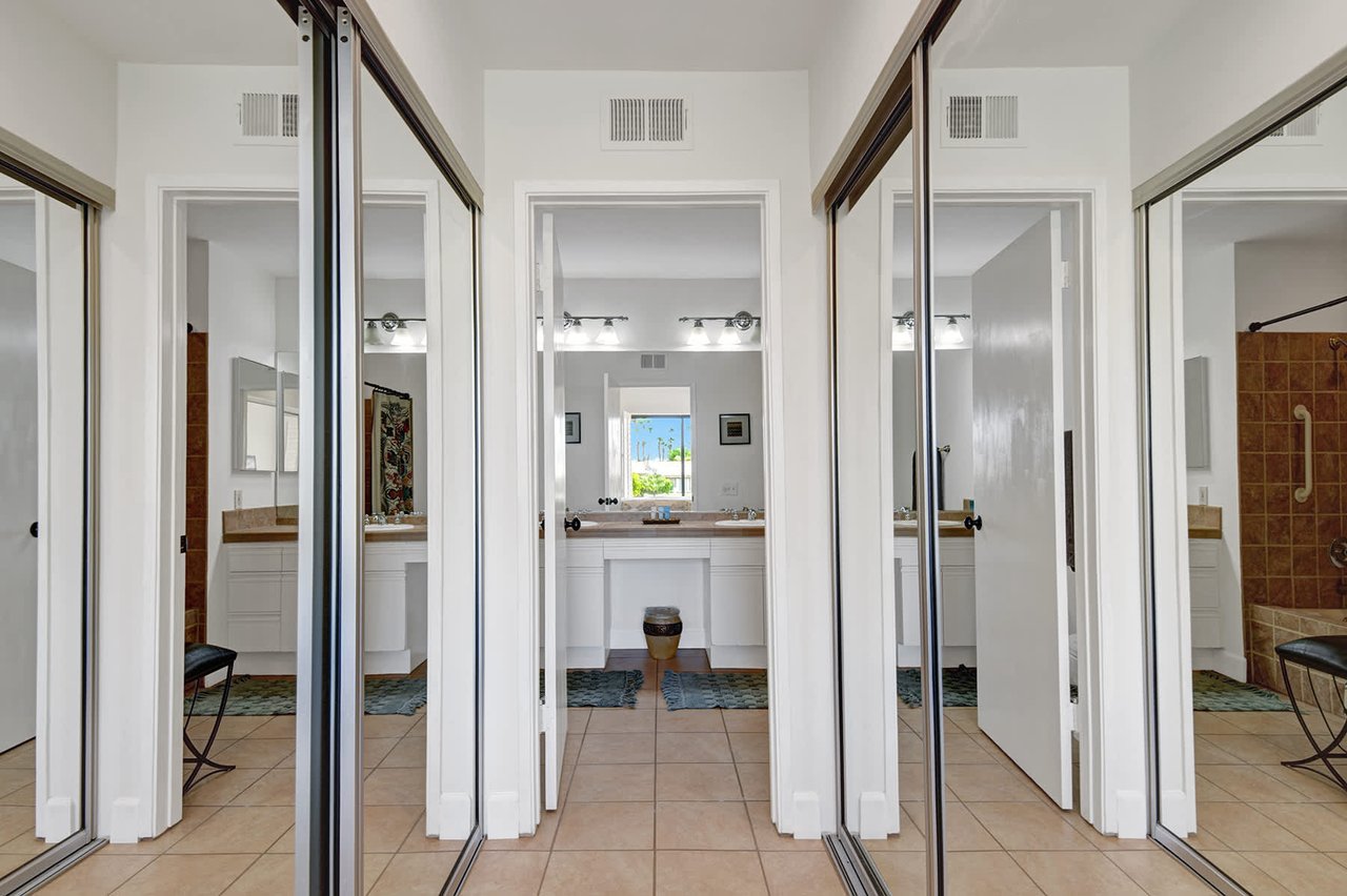 Step into your spacious private retreat featuring elegant tile flooring, a dedicated vanity area, and a luxurious tiled shower. The bright, airy design welcomes you to unwind and refresh.