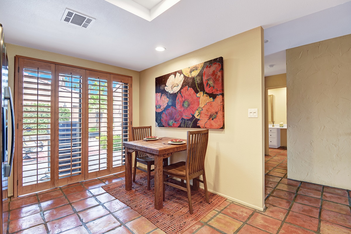 Enjoy morning coffee at your private dining nook, where warm wood tones and charming shutters create an inviting space to plan your day's adventures.