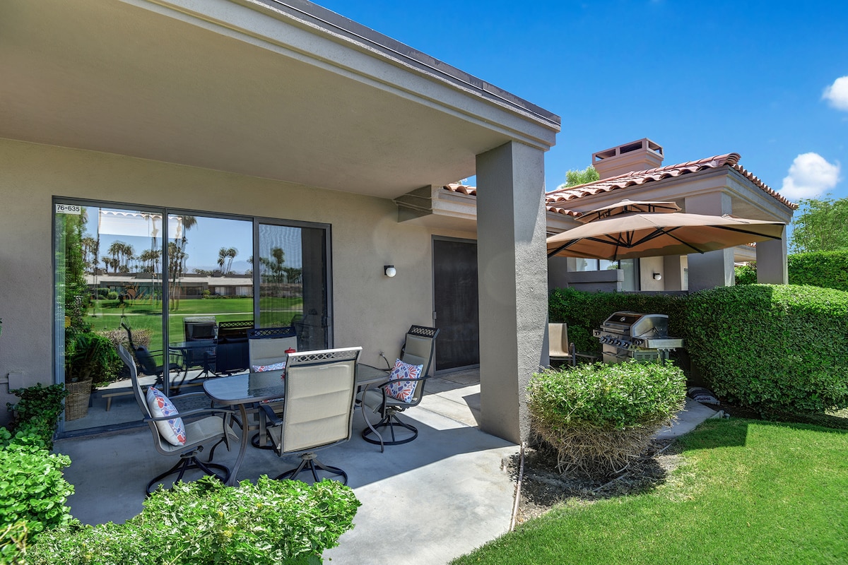 Covered patio with dining and BBQ area overlooking lush garden and views beyond. Perfect for your morning coffee or evening gatherings.
