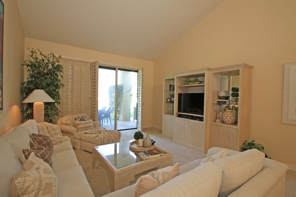 Unwind in this bright, inviting living room with plush seating and a glass-top coffee table. Open the patio doors to let fresh air flow in while you relax in your comfortable home away from home.