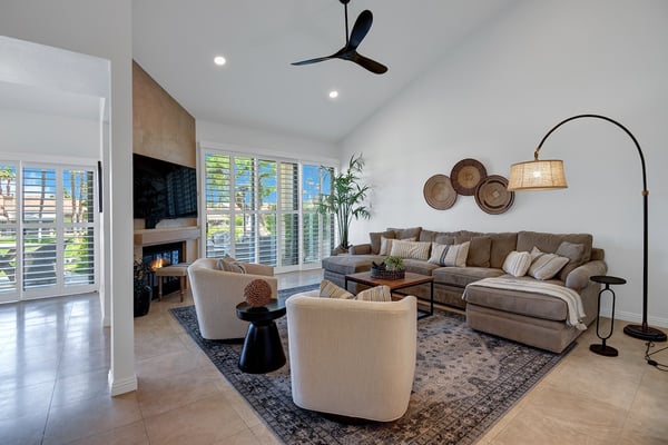 Sink into plush seating and unwind in this bright, airy living room. Vaulted ceilings and natural light invite relaxation, while the cozy fireplace sets the perfect mood for your getaway.