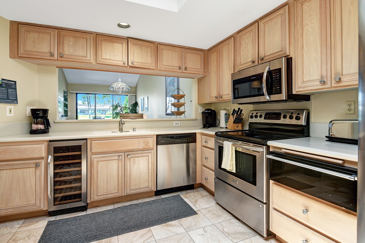 Your fully equipped kitchen offers ample counter space, stainless appliances, and a wine cooler—perfect for preparing meals and entertaining. Natural light pours in, making cooking feel effortless.