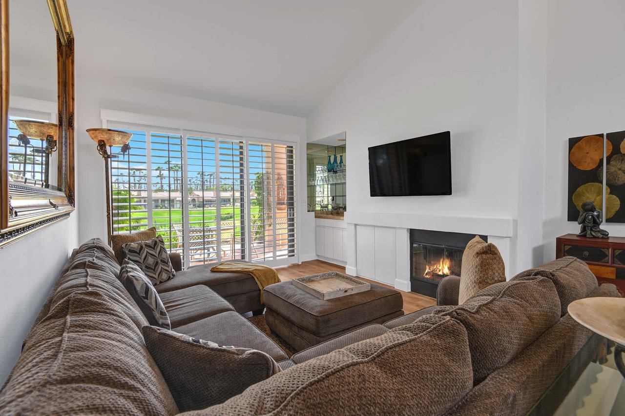Sink into plush seating by your cozy fireplace, where soft light streams through plantation shutters. This inviting living room is your perfect spot to unwind after a day of adventure.