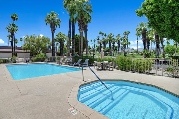 Two sparkling pools framed by swaying palms and desert sunshine, creating your perfect oasis for lounging, cooling off, and soaking up warm-weather vibes.