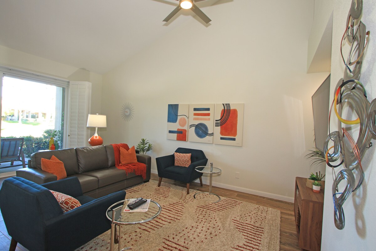 Step inside your bright, modern living space where vaulted ceilings and stylish mid-century touches welcome you. Sink into comfortable seating or gaze through doors to your private outdoor area.
