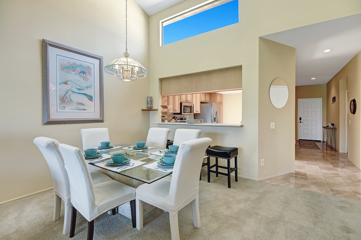 Gather around this elegant dining table where morning light pours in through soaring windows. With seating for six and open sightlines to your bright kitchen, your group meals here will feel effortlessly connected.
