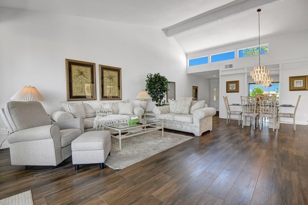 Step into your bright, airy living space where vaulted ceilings and sunlight create an effortlessly elegant atmosphere for relaxing and gathering with loved ones.