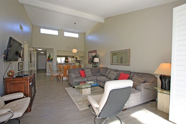 Sink into the plush sectional and unwind in your bright, airy living space with vaulted ceilings and natural light streaming through clerestory windows. Your open-concept retreat is designed for relaxed desert living.