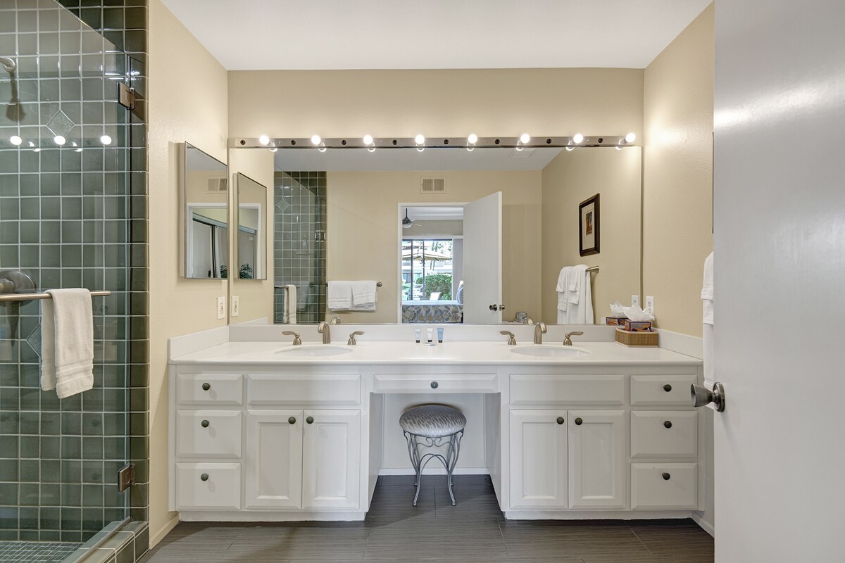 Step into your bright, beautifully lit bathroom with dual vanities, perfect for getting ready in comfort. Enjoy the elegant tiled shower and ample storage in this thoughtfully designed space.