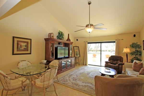 Relax in your bright, open living space with soaring ceilings and plenty of room to gather. Glass doors invite natural light and open to your private outdoor area.