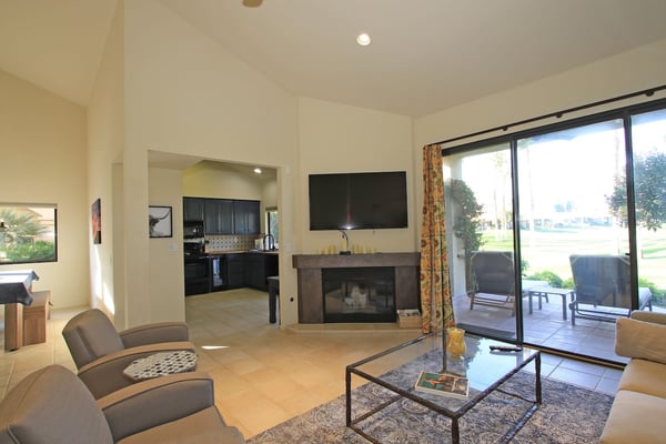 Settle into your spacious living room, where a cozy fireplace and modern comforts create the perfect spot to unwind after a day of desert adventure.