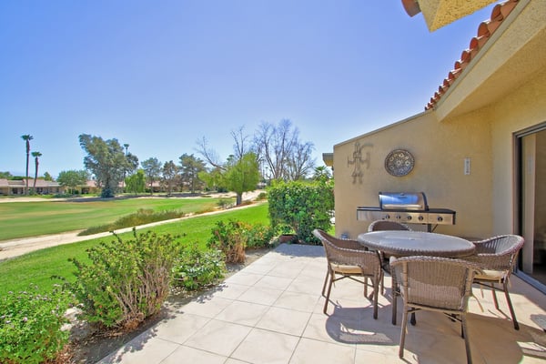 The property is located within a golf course community surrounded by lush green fairways and mature trees.