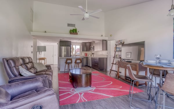 Your open-concept retreat invites you to unwind with vaulted ceilings, a fully equipped kitchen with stainless appliances, and a cozy living area perfect for gathering after exploring nearby attractions.