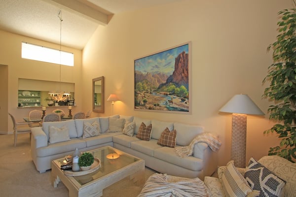 Step into your bright, airy living room where a plush sectional invites you to unwind after a day of adventure. Warm desert tones and elegant touches create a welcoming retreat.