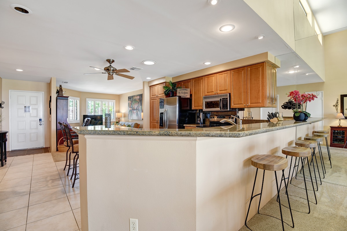 Your gourmet kitchen features a spacious island with bar seating, granite countertops, and stainless steel appliances—perfect for preparing meals or gathering with loved ones over morning coffee.