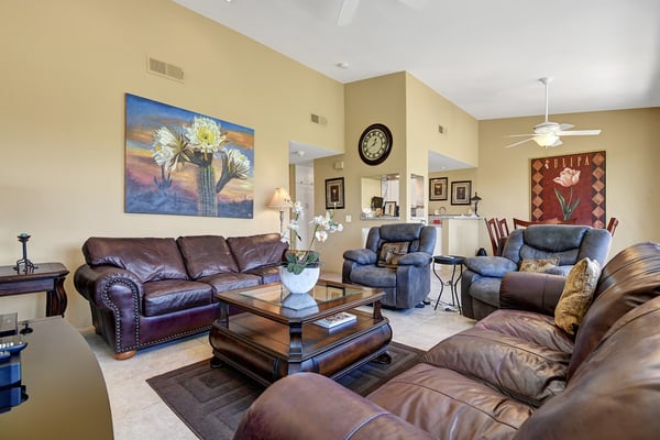 Settle into plush leather sofas and relax beneath soaring vaulted ceilings in your spacious living area, designed for ultimate comfort and conversation.