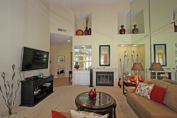Settle into your spacious living area where warm neutral tones and pops of color create the perfect retreat. A cozy fireplace and plush seating invite relaxation after your day's adventures.