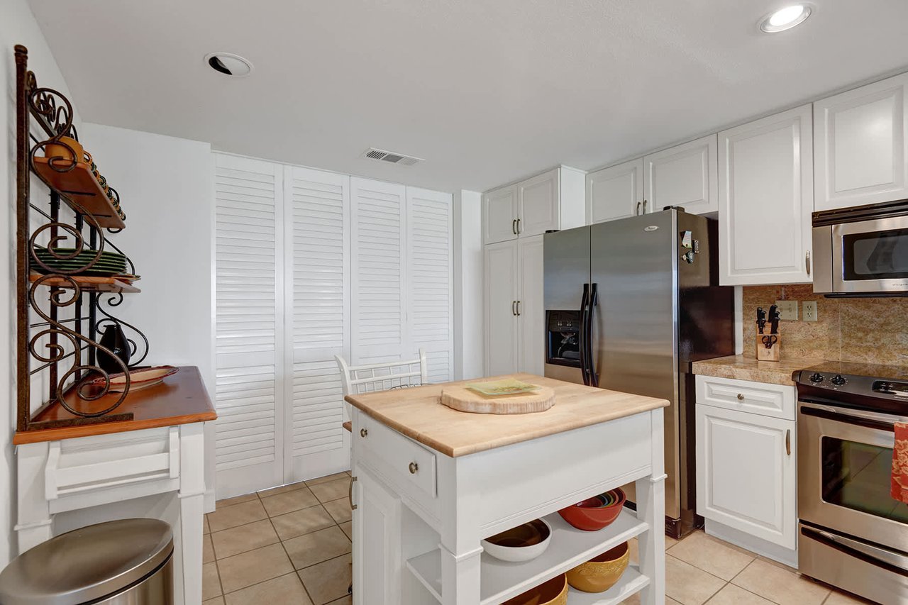 Your fully equipped kitchen awaits with stainless steel appliances and plenty of counter space for preparing memorable vacation meals together.
