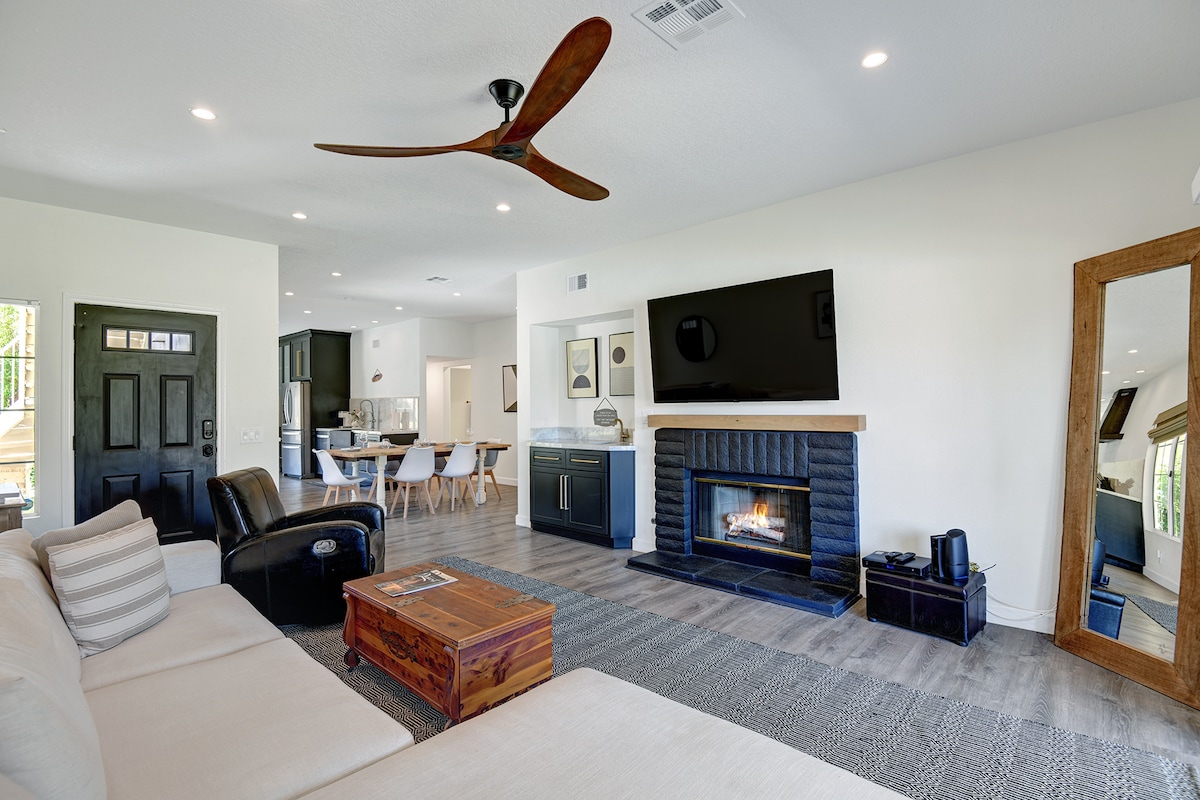 Sink into plush seating and enjoy the warmth of your own fireplace in this bright, open living space. The modern design flows seamlessly into the dining and kitchen areas, perfect for gathering with loved ones.