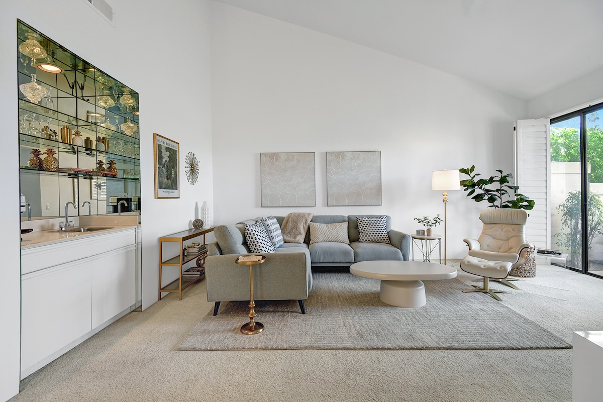 Settle into your serene living space, where clean lines and natural light create the perfect retreat. Stylish glass shelving adds a modern touch, while plush seating invites you to unwind after exploring.