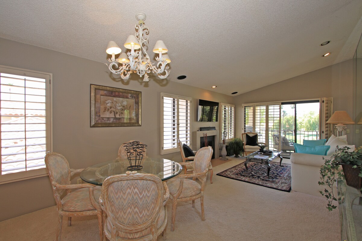 Your spacious retreat flows seamlessly from dining to living, where an elegant chandelier sets the mood and natural light pours through plantation shutters. Step beyond the fireplace to discover your private balcony overlooking the sparkling pool.