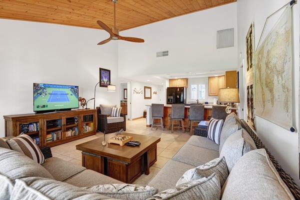 Settle into plush seating under soaring wood ceilings as you unwind in your open-concept living space. Your fully equipped kitchen and dining area flow seamlessly, creating the perfect home base for your getaway.